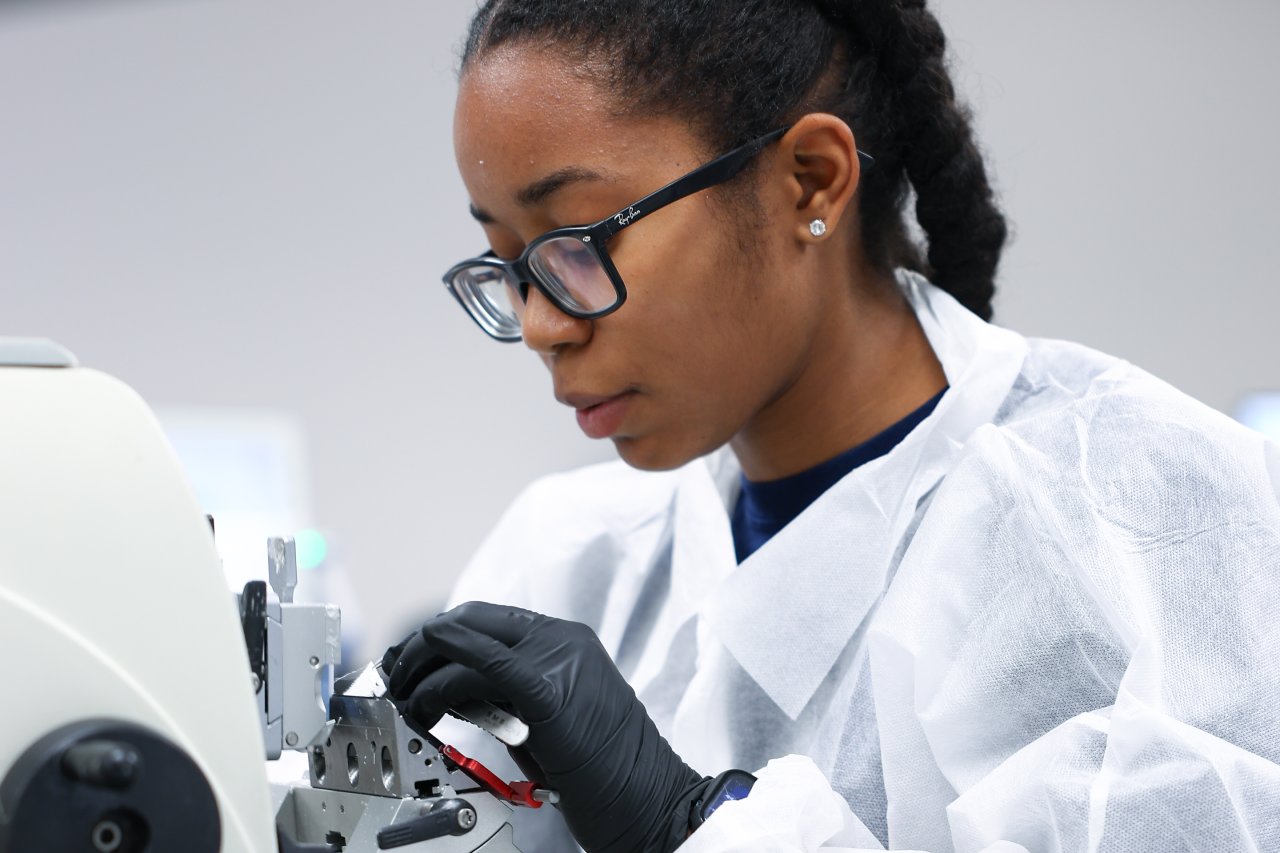 A woman working with sensitive equipment in a lab